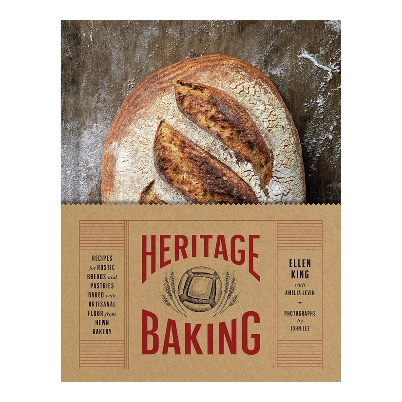 Loaf of bread with a heritage baking label on a wooden surface.