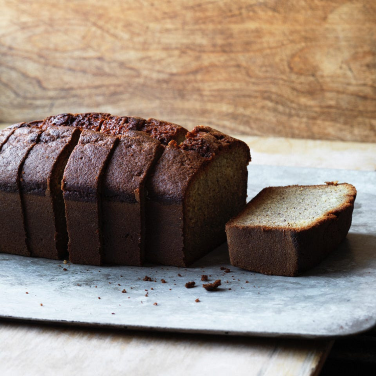 A loaf of sliced bread on a wooden surface.